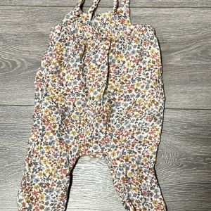 Flower romper with straps.